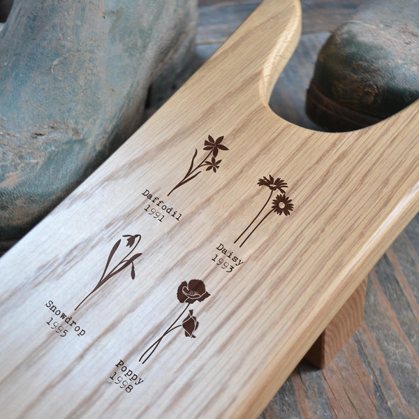 Oak Boot Jack engraved with 'Birth Flower'design and the year of birth for each child